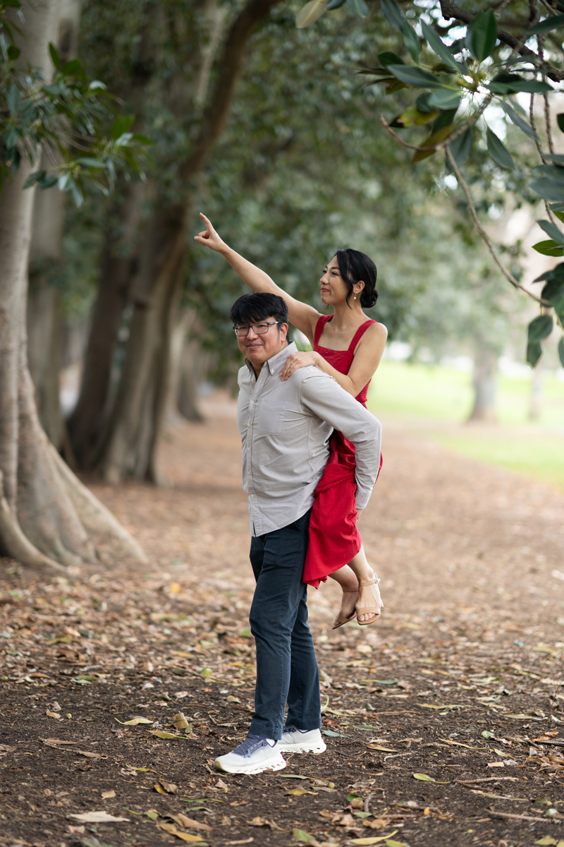 Husband hugging fiancee in the park